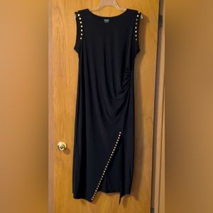 Black fitted maxi dress with diagonal slit at the knee with decorative spots